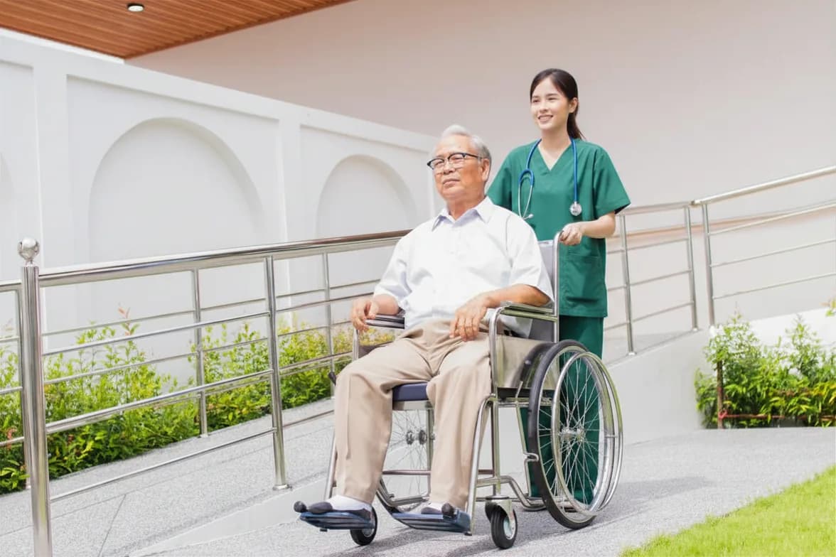 Caregiver assisting an older adult at home with daily activities